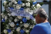  ?? RINGO H.W. CHIU — THE ASSOCIATED PRESS ?? A wreath is displayed at a memorial outside El Monte City Hall on Wednesday after two police officers were shot and killed Tuesday at a motel in El Monte.