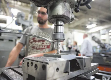  ?? BLOOMBERG PHOTO ?? A student works on a milling machine cutting metal at the vocational training centre in Montmagny, Quebec, in 2017.