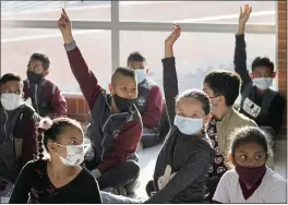  ?? FERNANDO VERGARA — THE ASSOCIATED PRESS ?? Students attend their first day back to in-person learning amid the COVID-19pandemic Monday at the Emma Villegas public school in Bogota, Colombia.