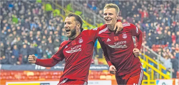  ??  ?? RED-HOT STRIKE: Gary Mackay-Steven, right, celebrates with Stevie May after scoring the only goal in last night’s windy match against Hibs – Match report – Pages 62-63