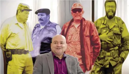  ??  ?? BOGOTA: FARC commander Carlos Lozada speaks during an interview with AFP in front of the images of late FARC leaders, left to right, Manuel Marulanda Velez, Jorge Briceno Suarez, Jacobo Arenas and Alfonso Cano in Bogota. — AFP