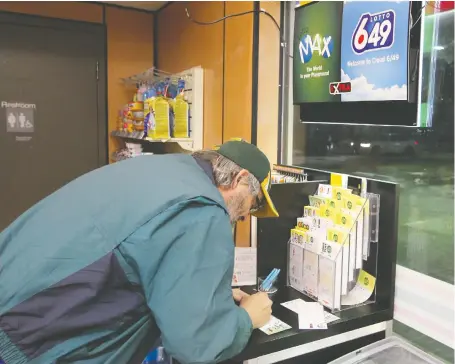  ?? BRENDAN MILLER ?? Todd Beckman makes his picks as he joins thousands of Calgarians who were hoping and fantasizin­g about winning the big jackpot Friday as Lotto Max’s draw climbed to $70 million.