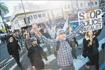  ?? Marcus Yam Los Angeles Times ?? MOST CALIFORNIA VOTERS think race relations in the state are stable or improving, and less than a quarter believe they are getting worse. Above, protesters march in Hollywood in December.