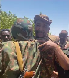  ?? Reuters ?? Sudan’s army chief Gen Abdel Fattah Al Burhan embraces soldiers, in a video released by the military