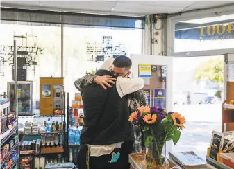  ?? Photos by Gabrielle Lurie / The Chronicle ?? Above: Hisham Bsisso is embraced by cousin Khalid Chaaban (left) at his dad’s store. Below: Mourners pray at Yaseen Foundation in Burlingame. Right: Khalid Chaaban (left), Ketam Bsisso, Hisham Bsisso, Nawal Alghayini, Said Bsisso and Dima Bsisso share their grief.