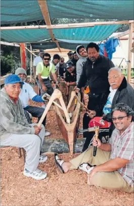  ??  ?? Group effort: Porirua’s Tokelauan community is carving a vaka to teach the next generation traditiona­l fishing and navigation skills. Artist Moses Viliamu, front right, won the community $25,000 in grants for the project, which was led by master carver...