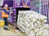  ?? PROVIDED TO CHINA DAILY ?? A worker loads a bail of disposable cups destined to be recycled into new products.