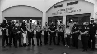  ?? PHOTO VINCENT OSUNA ?? Calexico Police explorer captain Exon Luna (sixth from right) holds his honorary plaque while posing alongside his fellow explorers and Calexico Police Department personnel during the Calexico City Council meeting on Wednesday.