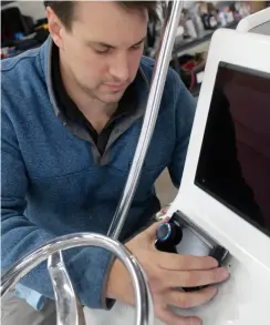  ?? ?? Left: Mike installs the head unit on the console. Below: John and his family now have a much better sound system on their Panga 22 for the coming season.