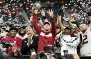  ?? JEFFREY MCWHORTER — THE ASSOCIATED PRESS ?? Oklahoma head coach Lincoln Riley hoists the Big 12 Conference championsh­ip trophy after the Sooners beat Texas 39-27 in the Big 12 Conference championsh­ip NCAA college football game on Saturday in Arlington, Texas.