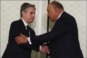  ?? (AP/Evelyn Hockstein) ?? U.S. Secretary of State Antony Blinken (left) shakes hands Thursday with Egyptian Foreign Minister Sameh Shoukry after a joint news conference during his visit to Cairo.
