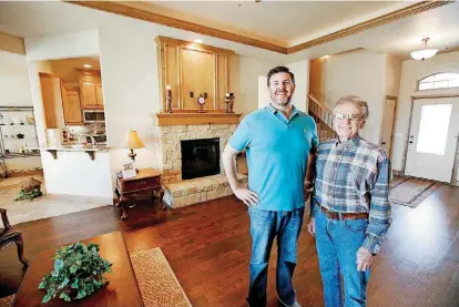  ?? [PHOTOS BY STEVE GOOCH, THE OKLAHOMAN] ?? Builders Michael Carr, left, and his father, Dave Carr, show the open layout at 15320 Deer Valley Trail in Deer Valley Estates, their first addition, north of NW 150 and west of Rockwell Avenue.