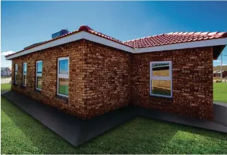  ?? PICTURE: YOUR HOUSING COMPANY ?? BUYING UP AND DOWN Properties in the affordable housing category, like this home in Soweto, are becoming more popular with buyers upgrading from the informal property sector, and those in the formal sector who are downgradin­g. |