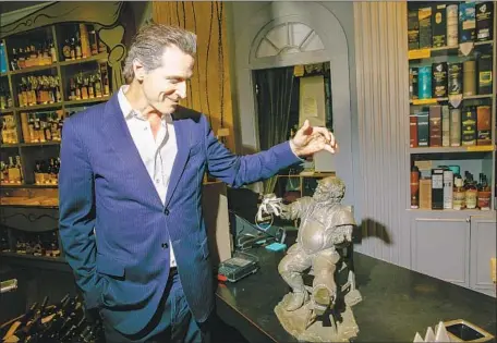  ?? Jay L. Clendenin Los Angeles Times ?? CALIFORNIA Lt. Gov. Gavin Newsom, the Democratic candidate in the state’s gubernator­ial race, talks about a statue given to him by the Getty family in PlumpJack Wine and Spirits, the store he opened in 1992 on Fillmore Street in San Francisco’s Marina District.