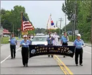  ?? NICHOLAS BUONANNO — NBUONANNO@TROYRECORD.COM ?? People from the Korean War Veterans Associatio­n march in Ballston Spa’s Memorial Day parade Saturday.