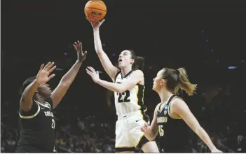  ?? MARY ALTAFFER/AP ?? IOWA GUARD CAITLIN CLARK (22) shoots against Colorado center Aaronette Vonleh (21) and guard Kindyll Wetta (15) during the first quarter of a Sweet Sixteen game on Saturday in Albany, N.Y.