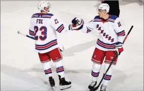  ?? Elsa / Getty Images ?? The Rangers’ Ryan Strome, right, is congratula­ted by teammate Adam Fox after Strome scored an empty-net goal in the third period against the New Jersey Devils at Prudential Center on Saturday in Newark, N.J.