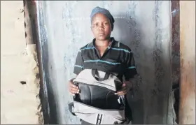  ?? Photo: Emmency Nuukala ?? Committed mom… Saima Shivandu shows her son's school bag. She is currently unable to afford the correct one required by the school.