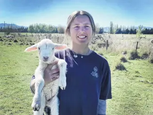  ?? PHOTO: SUPPLIED ?? Down on the farm . . . City Highlander­s goal keeper Ginny Wilson at work on her family’s Middlemarc­h farm yesterday.