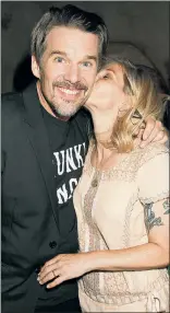  ??  ?? Ethan Hawke gets a smooch from his wife, Ryan, at an NYC after-party following a special screening of his movie “Blaze.” [More on “Blaze,” Page 30.]