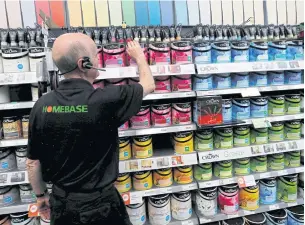  ?? REUTERS ?? A sales assistant tidies up a shelf of paint at a Homebase store in Aylesford, Britain in this file photo.