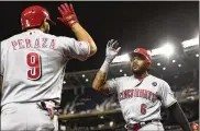  ?? PATRICK MCDERMOTT / GETTY IMAGES ?? Phillip Ervin celebrates with Reds teammate Jose Peraza after hitting a solo home run in the ninth inning Monday. The Reds scored twice in the ninth to close the gap before falling 7-6 to the Nationals.