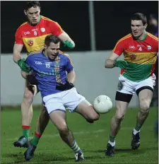  ??  ?? John McGrath feels the pressure from Carlow’s Brendan Murphy.