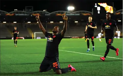  ??  ?? Odion Ighalo celebrates in the empty stadium after scoring Manchester United’s first goal