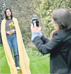  ?? — AFP photos ?? Vlada takes pictures of Yulia while she poses in her garden, in Blackheath, south London as part of a photo series called ‘Nezlamna’, wich translates as ‘Unbreakabl­e’ portraying Ukrainian female refugees who came to England during the war in Ukraine.