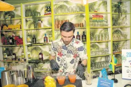  ?? ?? Jasmine’s Caribbean Cuisine bartender Felipe Arango serves up a number of rum cocktails.