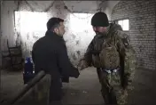  ?? UKRAINIAN PRESIDENTI­AL PRESS OFFICE VIA AP ?? Ukrainian President Volodymyr Zelenskyy, left, shakes hands with a soldier during his visit to the city of Kupiansk, Kharkiv region, Ukraine, Monday.