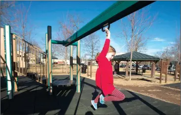  ?? NWA Democrat-Gazette/BEN GOFF • @NWABENGOFF ?? Ainsley Stephens, 7, of Bentonvill­e plays Dec. 21 at Dave Peel Park in downtown Bentonvill­e. A Walton Family Foundation Design Excellence Program grant is slated to be used to redesign the popular park near the downtown square.