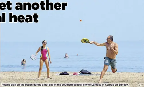  ?? AP ?? People play on the beach during a hot day in the southern coastal city of Larnaca in Cyprus on Sunday.