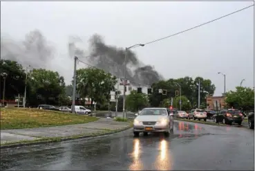  ?? ARIEL ZANGLA — DAILY FREEMAN ?? Smoke rises from the transforme­r fire on Frog Alley in Uptown Kingston on Tuesday. This photo was taken on Hurley Avenue, near the intersecti­on with Washington Avenue.