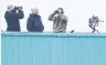  ?? PHOTO: REUTERS ?? Snipers watchover the tarmac before the arrival of United States President Donald Trump ahead of the Nato summit, at Brussels Military Airport, Melsbroek, Belgium. yesterday.