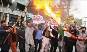 ?? SS MIRZA/AFP ?? Pakistani protesters torch an Indian flag during a demonstrat­ion in Multan on Wednesday against cross-border firing by Indian troops.