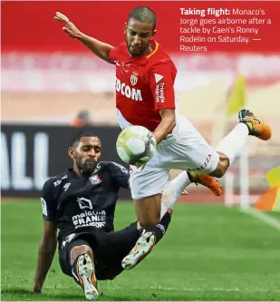  ??  ?? Taking flight: Monaco’s Jorge goes airborne after a tackle by Caen’s Ronny Rodelin on Saturday. — Reuters