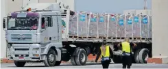  ?? | Reuters ?? A MAN operates a forklift by a truck carrying humanitari­an aid bound for the Gaza Strip at the Kerem Shalom crossing in southern Israel.