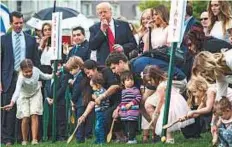  ?? Washington Post ?? President Donald Trump and first lady Melania Trump blow whistles to begin the Easter Egg Roll race on Monday.