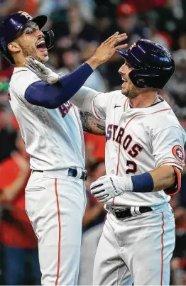  ?? Godofredo A. Vásquez / Staff photograph­er ?? Alex Bregman (2) celebrates with Carlos Correa after Bregman’s three-run shot in the third inning, his first home run since the second game of the season.