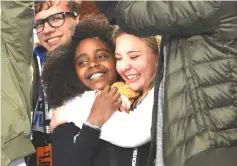  ??  ?? Wadler is hugged by Marjory Stoneman Douglas High School student Jaclyn Corin at the March for Our Lives last month in Washington, DC. — WP-Bloomberg photo