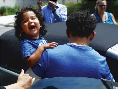  ?? AP FILE PHOTO ?? Ever Reyes Mejia, of Honduras, carries his son to a vehicle after being reunited and released by United States Immigratio­n and Customs Enforcemen­t in Grand Rapids, Mich.