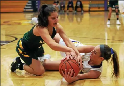  ?? RANDY MEYERS — THE MORNING JOURNAL ?? Avon’s Maggie Beatty and Audrey McConihe of Amherst dive on the floor after a loose ball during the first quarter.