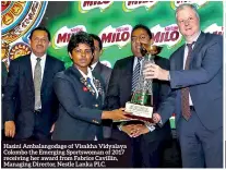  ??  ?? Hasini Ambalangod­age of Visakha Vidyalaya Colombo the Emerging Sportswoma­n of 2017 receiving her award from Fabrice Cavillin, Managing Director, Nestle Lanka PLC.