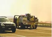  ?? JERILEE BENNETT AP ?? A firefighti­ng crew is seen in Colorado on May 12. Evacuation orders for the blaze remained in effect Thursday.