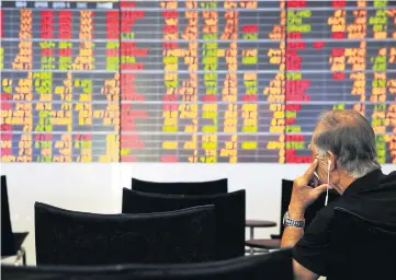  ?? WISIT THAMNGERN ?? An investor looks at electronic display of stock indices at the Stock Exchange of Thailand.