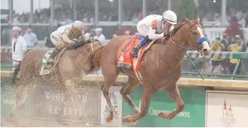  ?? — USA TODAY Sports photo ?? Mike Smith aboard Justify (right) beats Javier Castellano aboard Audible to the finish line to win the 144th running of the Kentucky Derby at Churchill Downs.