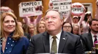  ?? AFP ?? Protesters stand and chanty with placards as mike Pompeo arrives to testify before the Senate Foreign relations committee during his conformati­on hearing on capitol Hill in Washington. —