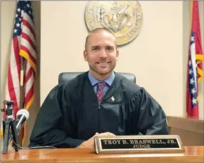  ?? TAMMY KEITH/RIVER VALLEY & OZARK EDITION ?? Circuit Judge Troy Braswell Jr. sits on the bench in a courtroom in the Faulkner County Justice Building in Conway. Braswell hears juvenile-court cases and often orders youth to one of several rehabilita­tion programs. The percentage of youth coming back to court multiple times has fallen dramatical­ly under Braswell’s tenure. “This is not about being soft on kids; this is about being smarter,” he said. On June 29, the Conway Morning Rotary Club presented him with the Outstandin­g Community Leader Award.