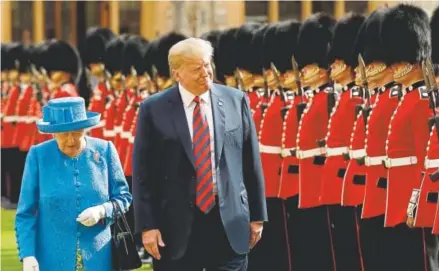  ??  ?? Queen Elizabeth II and President Donald Trump inspect a line of Coldstream Guards at Windsor Castle, west of London, on Friday. Coldstream Guards are the oldest continuous­ly serving regiment in the British army.